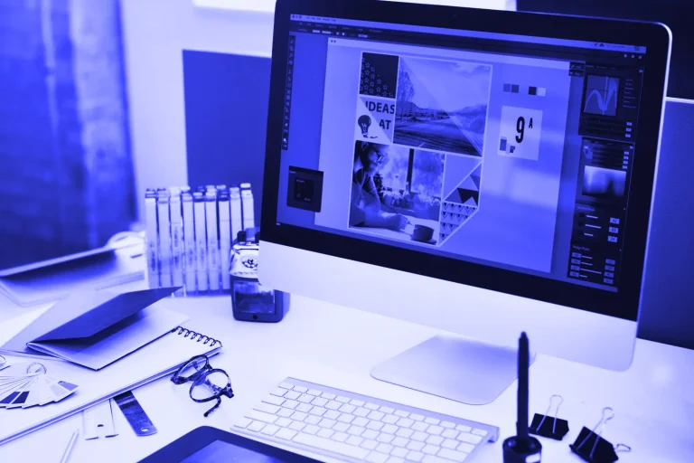 Designer workstation with a large monitor and sketches