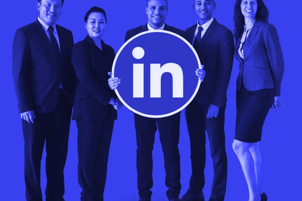 Business team holding a LinkedIn logo